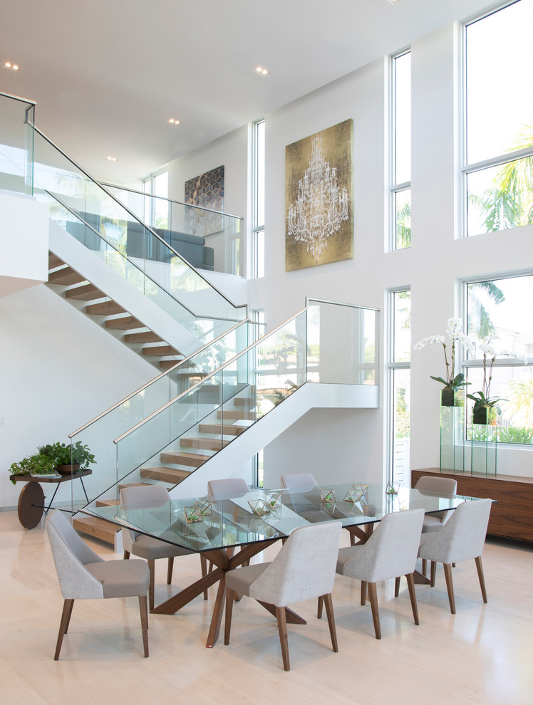 Inspiration for a contemporary dining room in Miami with white walls, beige floor and limestone floors.
