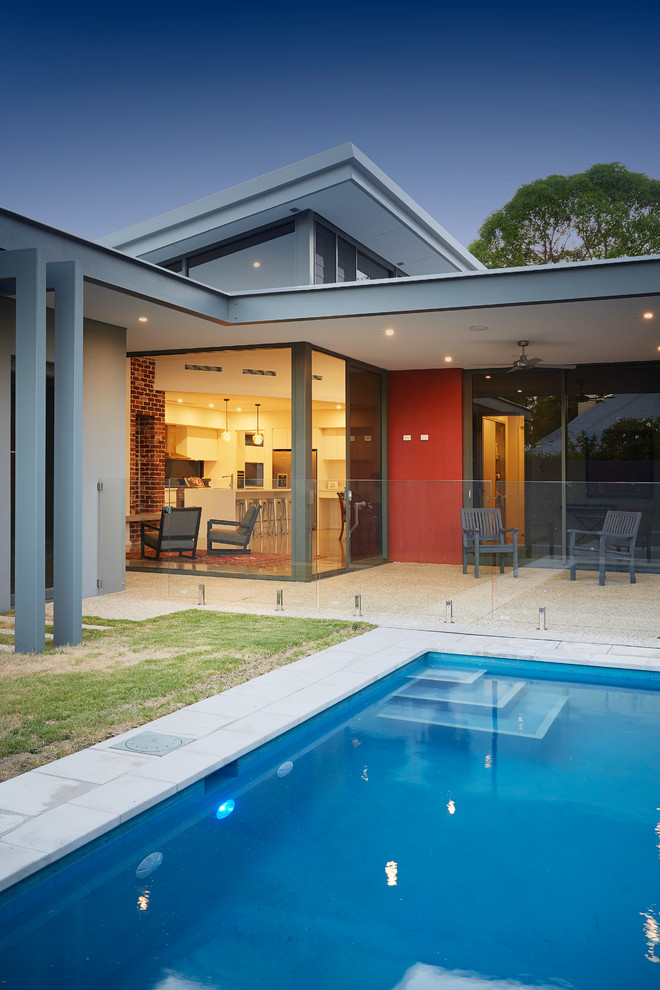Photo of a mid-sized contemporary one-storey red exterior in Perth with concrete fiberboard siding and a flat roof.