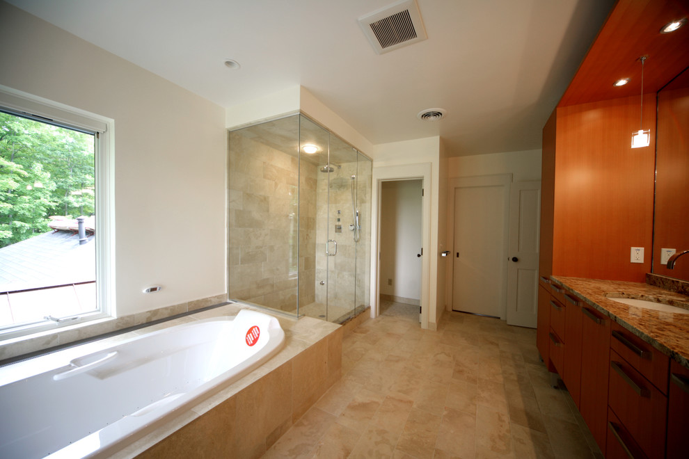 This is an example of a large contemporary bathroom in Burlington with flat-panel cabinets, medium wood cabinets, a freestanding tub, a two-piece toilet, beige tile, stone tile, white walls, travertine floors, an undermount sink, granite benchtops and with a sauna.