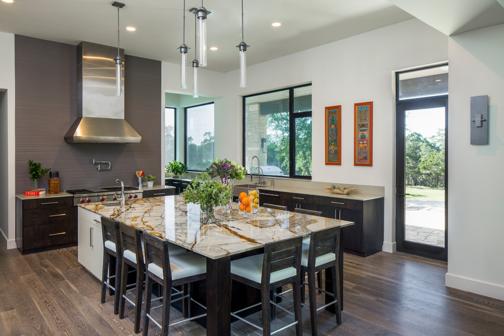 Contemporary kitchen in Austin with a farmhouse sink, dark wood cabinets, grey splashback, stainless steel appliances, dark hardwood floors and with island.
