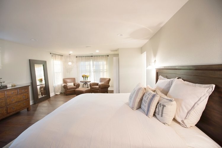 Large transitional master bedroom in Orange County with beige walls, dark hardwood floors, no fireplace and brown floor.