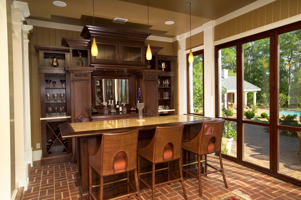 Transitional galley seated home bar in Atlanta with brick floors, open cabinets, dark wood cabinets and red floor.