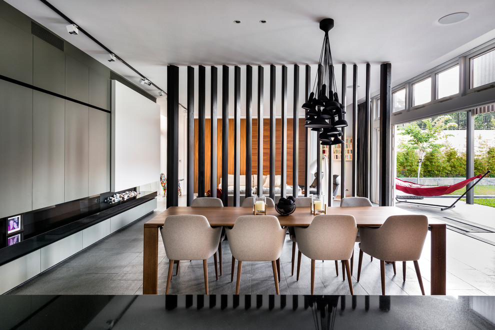 This is an example of a contemporary open plan dining in Perth with a ribbon fireplace.
