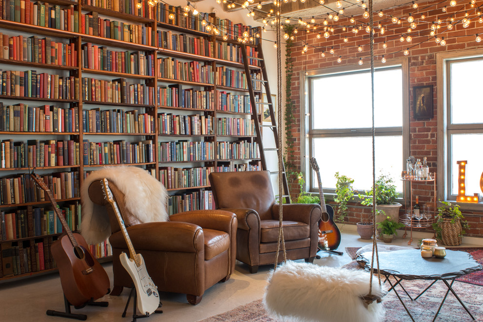 Eclectic loft-style concrete floor and gray floor living room library photo in Los Angeles with white walls