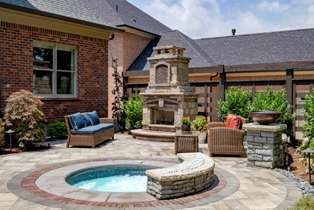 Small traditional backyard patio in Louisville with concrete pavers.