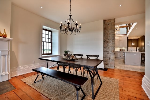 Inspiration for a mid-sized rustic medium tone wood floor and brown floor great room remodel in Toronto with white walls, a standard fireplace and a wood fireplace surround