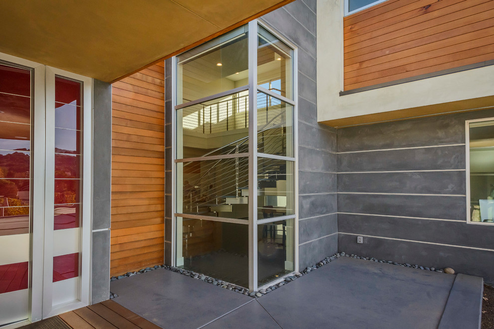 This is an example of a mid-sized modern two-storey grey house exterior in San Francisco with mixed siding.