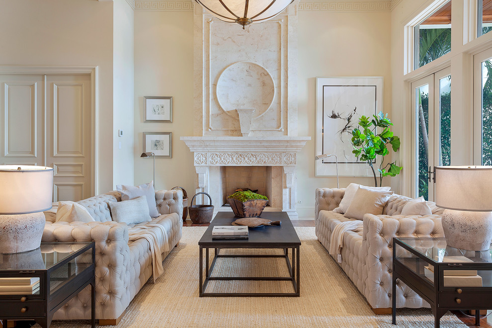 Transitional living room in Miami with beige walls, a standard fireplace, a stone fireplace surround and no tv.