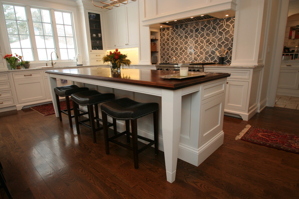Inspiration for a large transitional l-shaped dark wood floor open concept kitchen remodel in Chicago with flat-panel cabinets, white cabinets, granite countertops, blue backsplash, ceramic backsplash, stainless steel appliances and an island