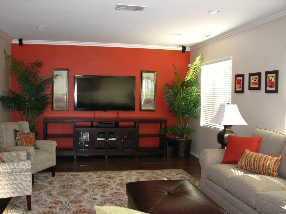 Example of a mid-sized transitional enclosed dark wood floor family room design in San Diego with red walls, no fireplace and a wall-mounted tv