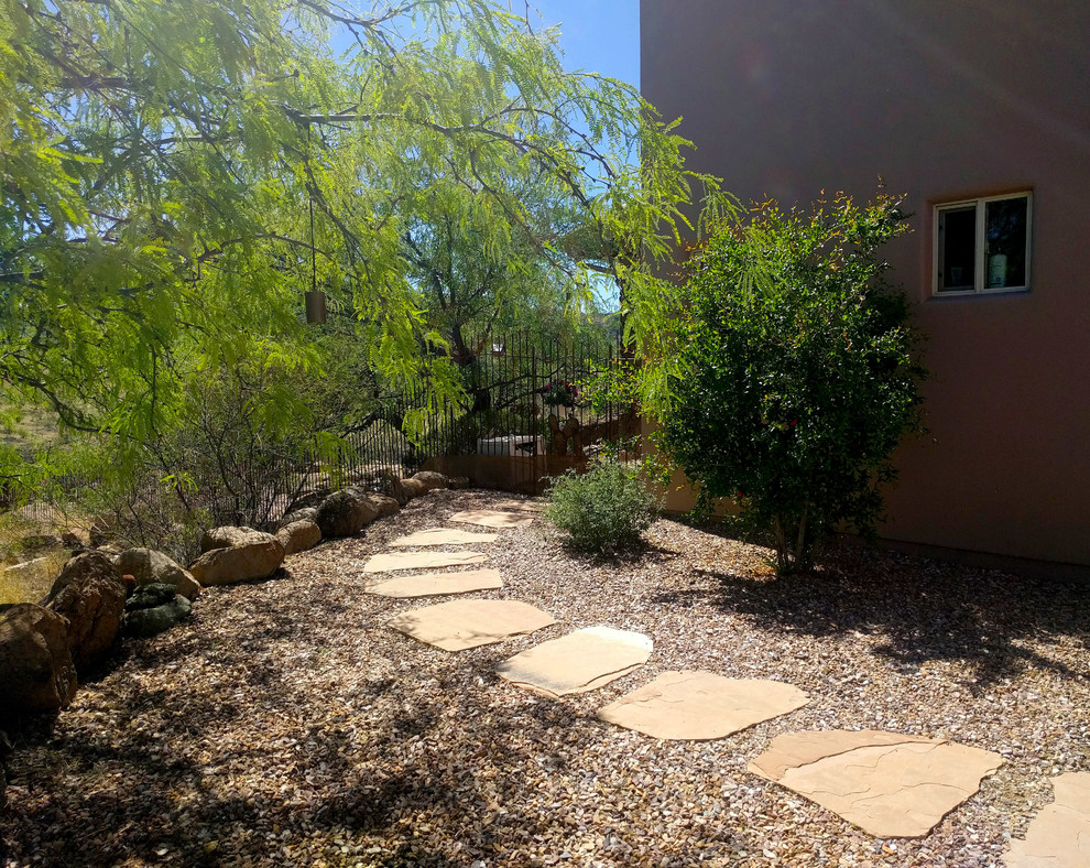 Side yard xeriscape in Phoenix with natural stone pavers for spring.
