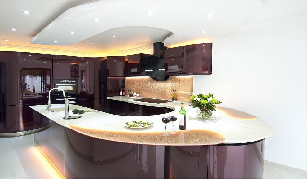 Photo of a large l-shaped open plan kitchen in London with an integrated sink, flat-panel cabinets, red cabinets, composite countertops, orange splashback, glass sheet splashback, coloured appliances, porcelain flooring and a breakfast bar.