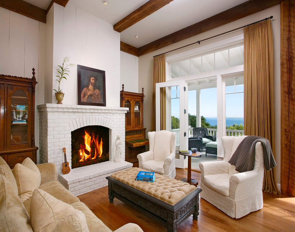 Design ideas for a traditional living room in Santa Barbara with white walls and medium hardwood floors.