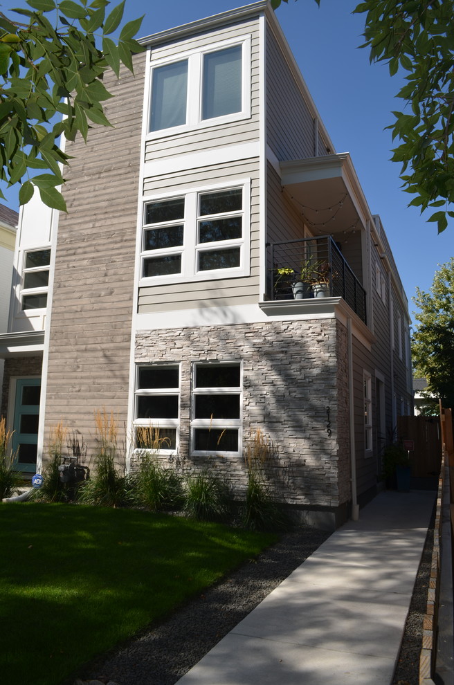 Photo of a mid-sized contemporary three-storey grey duplex exterior in Denver with mixed siding, a flat roof and a mixed roof.