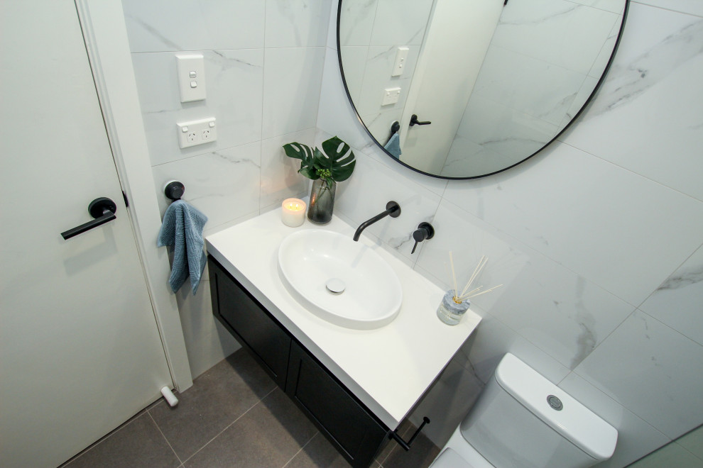 Small contemporary master bathroom in Sydney with black cabinets, an open shower, a two-piece toilet, an open shower, white benchtops, a single vanity and a floating vanity.