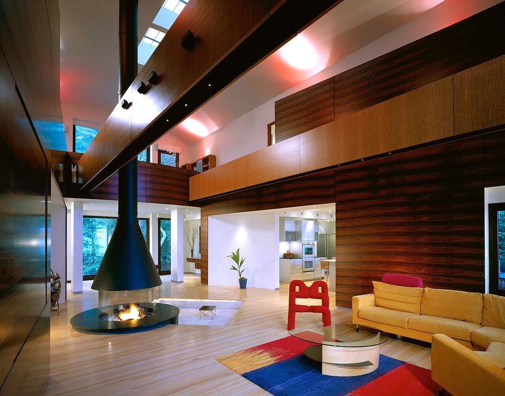 This is an example of an expansive contemporary loft-style living room in San Francisco with a hanging fireplace.