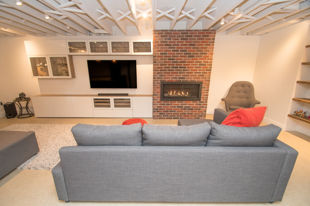 This is an example of a large industrial fully buried basement in Toronto with white walls, concrete floors, a standard fireplace and a brick fireplace surround.