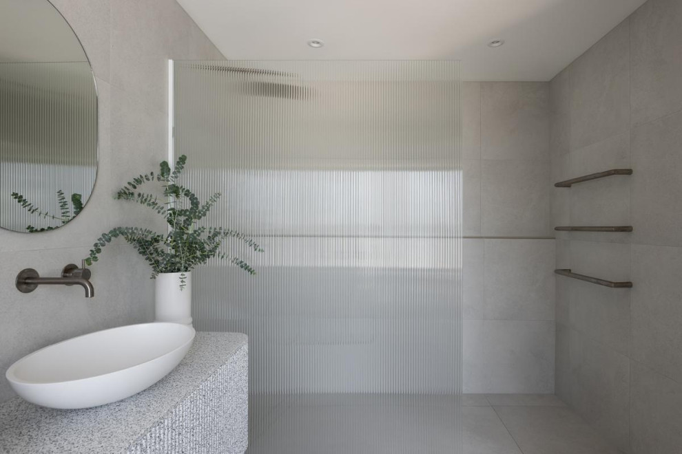 This is an example of a large modern master bathroom in Perth with furniture-like cabinets, grey cabinets, an open shower, gray tile, porcelain tile, grey walls, porcelain floors, a vessel sink, marble benchtops, grey floor, an open shower, grey benchtops, a shower seat, a double vanity and a floating vanity.