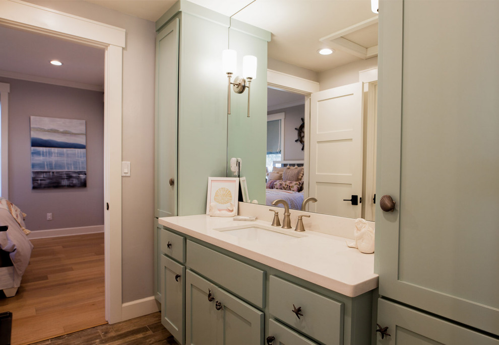 This is an example of a mid-sized beach style kids bathroom in San Diego with shaker cabinets, green cabinets, an alcove tub, a shower/bathtub combo, a two-piece toilet, white tile, ceramic tile, grey walls, terra-cotta floors, an undermount sink, engineered quartz benchtops, brown floor, a shower curtain and white benchtops.