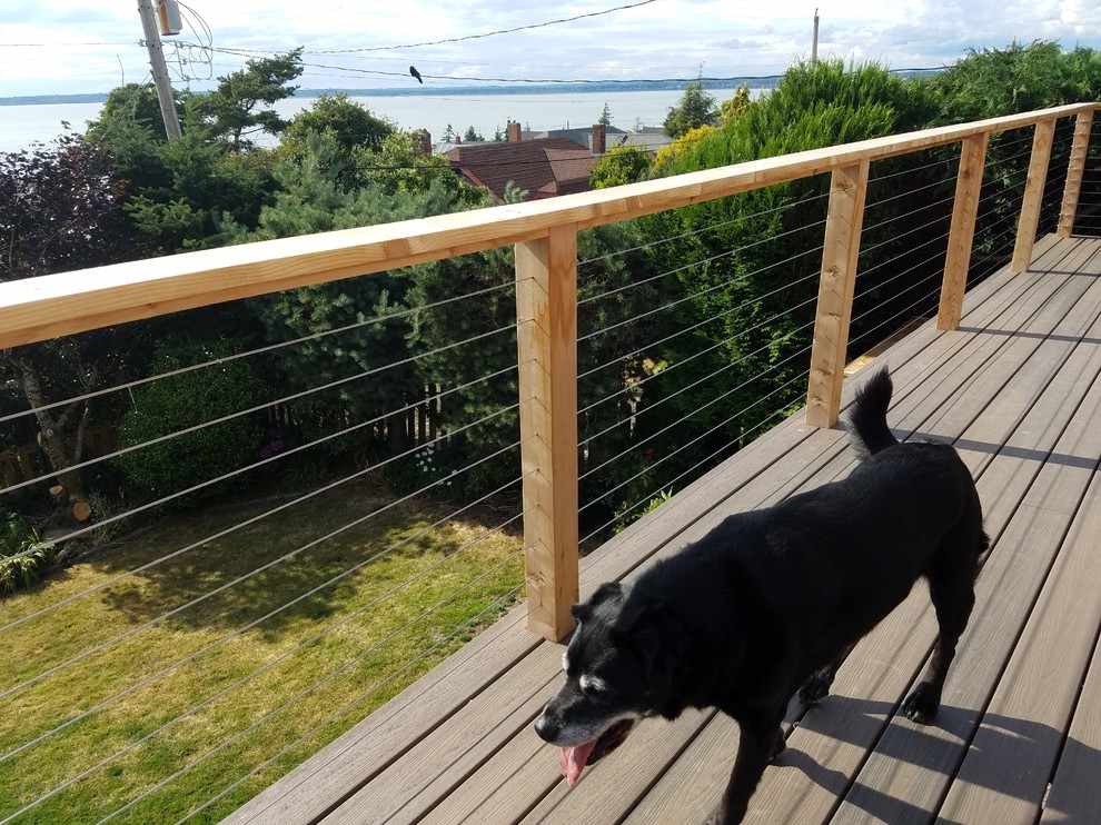 Design ideas for a large beach style backyard deck in Seattle.