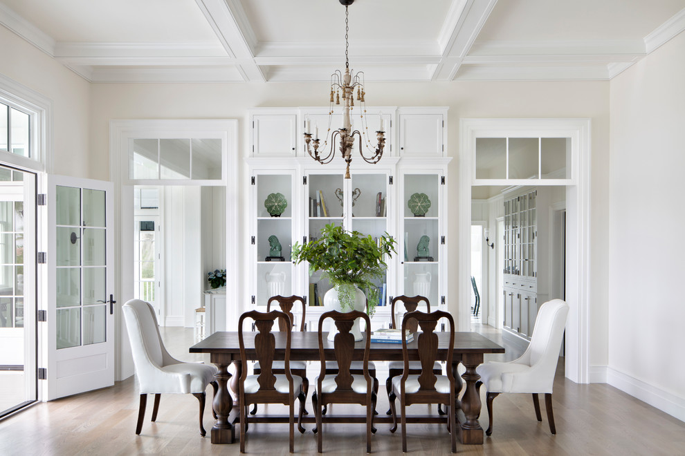 Photo of a large transitional dining room in Tampa with white walls, light hardwood floors, no fireplace and brown floor.