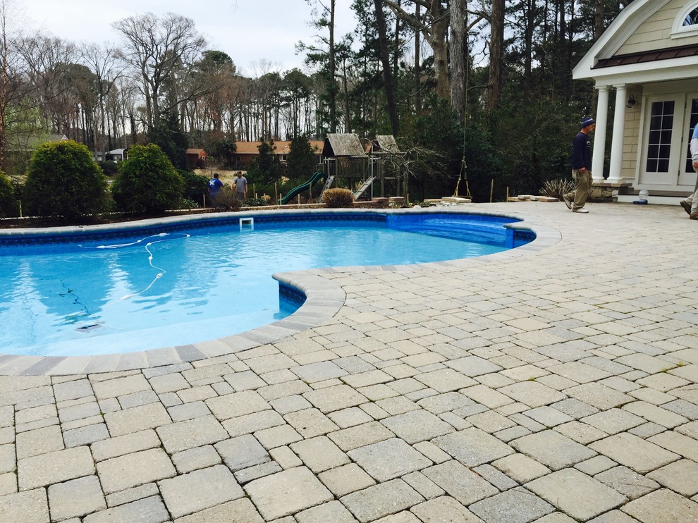 Mid-sized backyard stone and custom-shaped natural pool fountain photo
