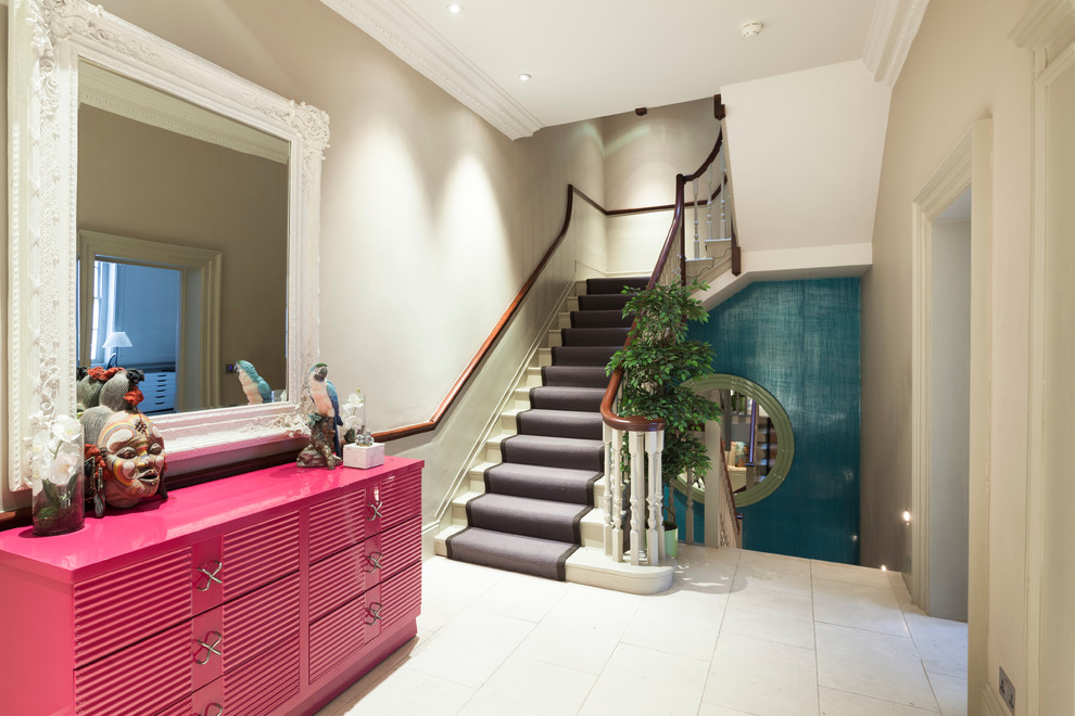 Photo of a contemporary painted wood l-shaped staircase in London with painted wood risers.