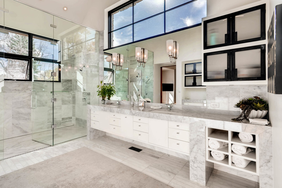 This is an example of a contemporary bathroom in Denver with flat-panel cabinets, white cabinets, a curbless shower, gray tile, grey walls, an undermount sink and a hinged shower door.