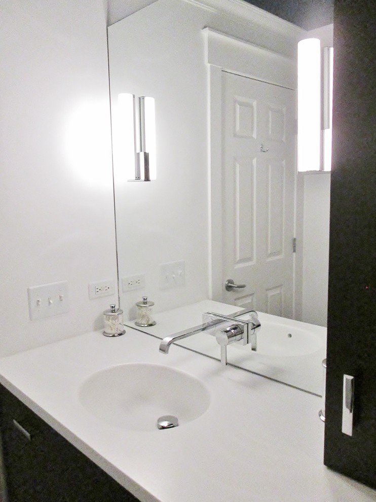 Example of a small transitional 3/4 white tile white floor bathroom design in Chicago with flat-panel cabinets, dark wood cabinets, a one-piece toilet, white walls, an integrated sink and solid surface countertops