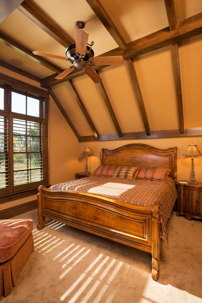 Inspiration for a large traditional master bedroom in Minneapolis with orange walls, carpet, no fireplace and brown floor.
