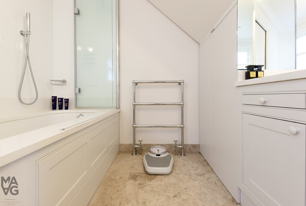 Design ideas for a mid-sized scandinavian kids bathroom in London with shaker cabinets, white cabinets, white walls, porcelain floors and a drop-in sink.