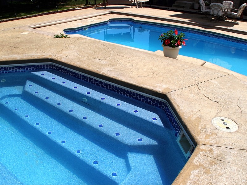 Hot tub - backyard stone and custom-shaped hot tub idea