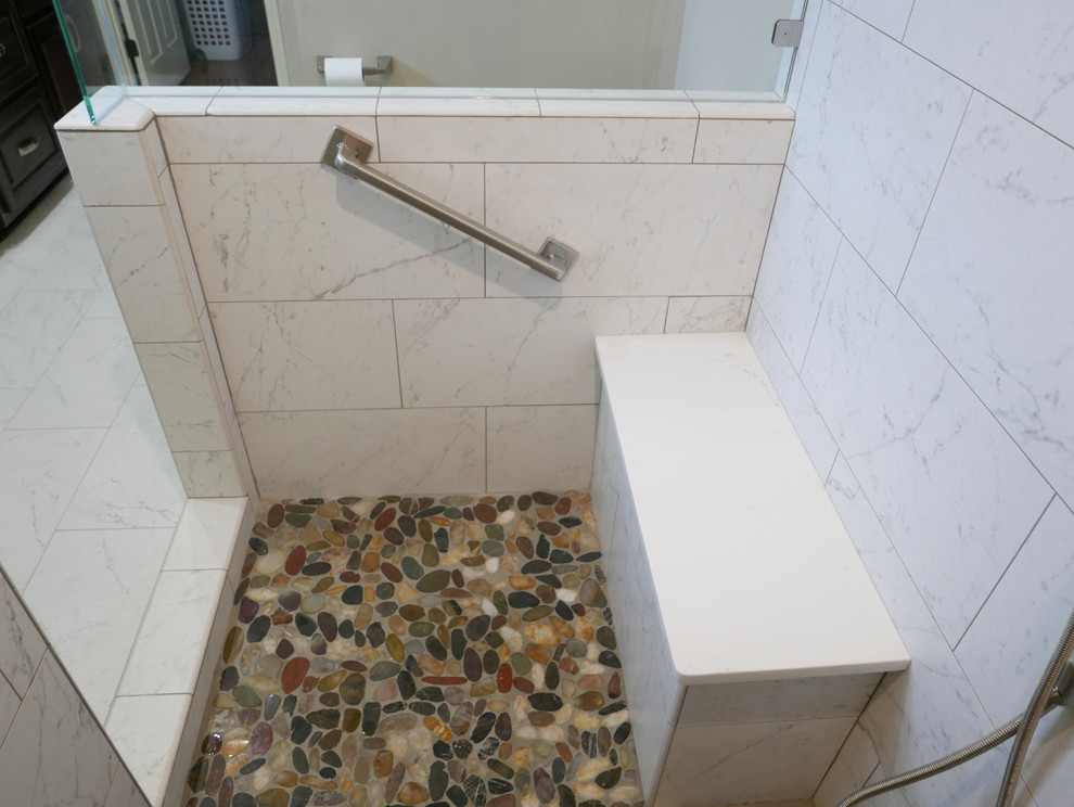 This is an example of a mid-sized transitional master bathroom in Other with raised-panel cabinets, dark wood cabinets, a corner shower, a two-piece toilet, white tile, porcelain tile, beige walls, porcelain floors, an undermount sink, engineered quartz benchtops, white floor, a hinged shower door and white benchtops.
