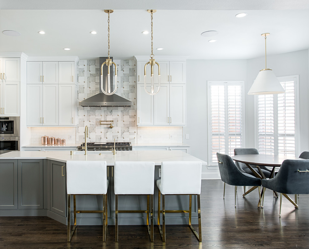 Huge transitional galley dark wood floor and brown floor eat-in kitchen photo in Dallas with an undermount sink, shaker cabinets, white cabinets, quartz countertops, white backsplash, marble backsplash, stainless steel appliances, an island and white countertops