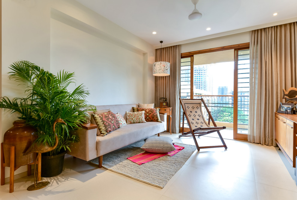 This is an example of an asian living room in Mumbai with white walls and white floor.