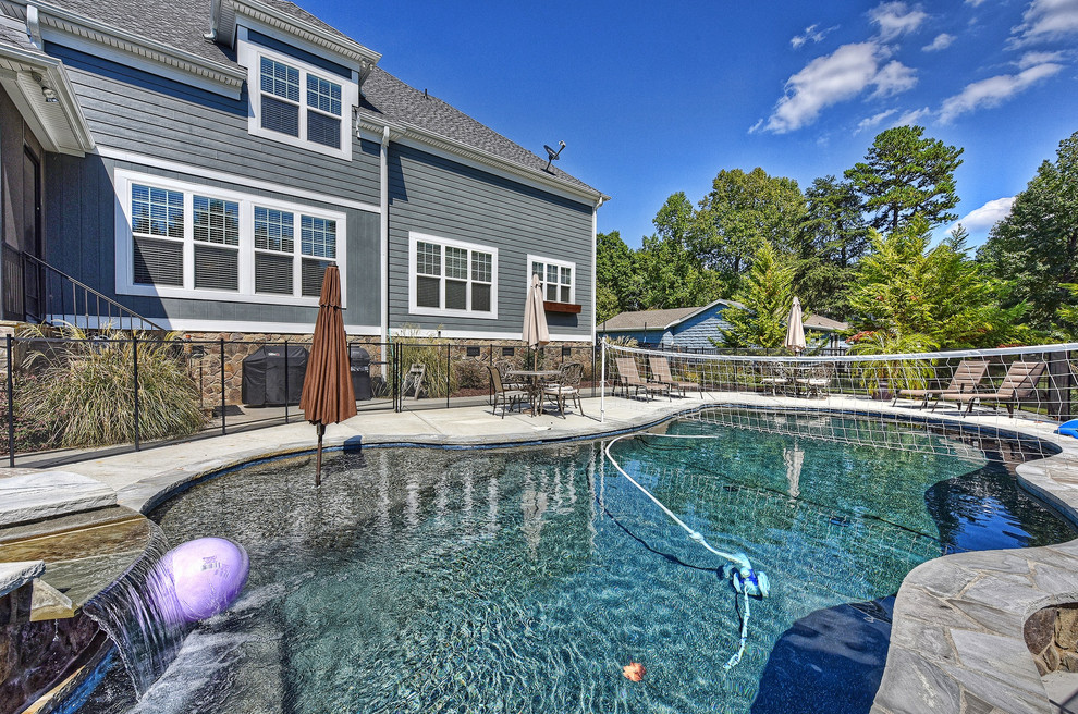 Inspiration for a transitional backyard concrete and kidney-shaped pool fountain remodel