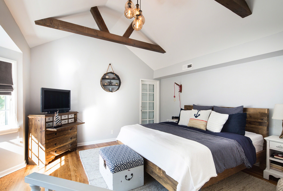Small beach style loft-style bedroom in Los Angeles with grey walls, medium hardwood floors and no fireplace.