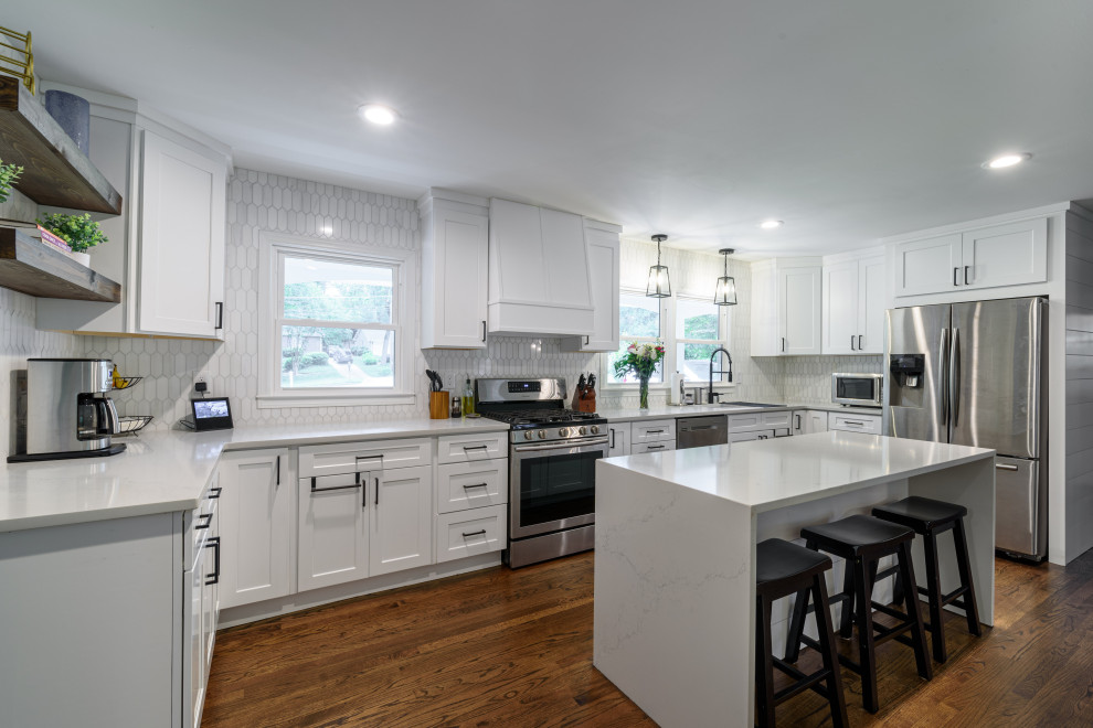 Kitchen - transitional u-shaped dark wood floor and brown floor kitchen idea in Atlanta with shaker cabinets, white cabinets, white backsplash, mosaic tile backsplash, stainless steel appliances, an island and white countertops