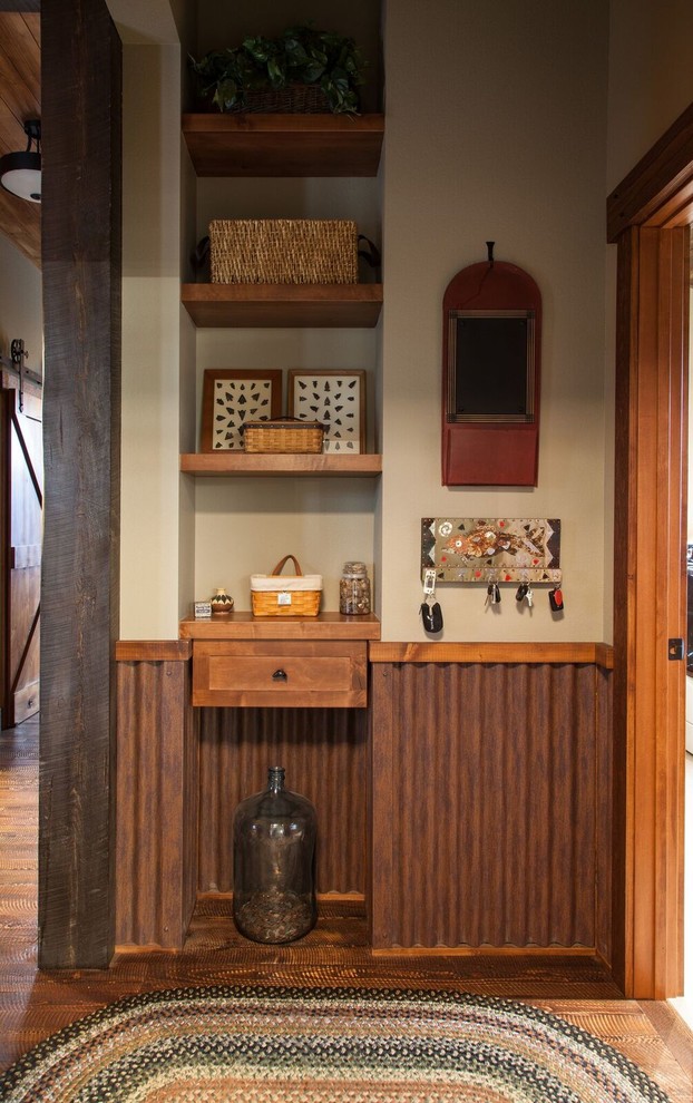 Small mountain style dark wood floor hallway photo with beige walls