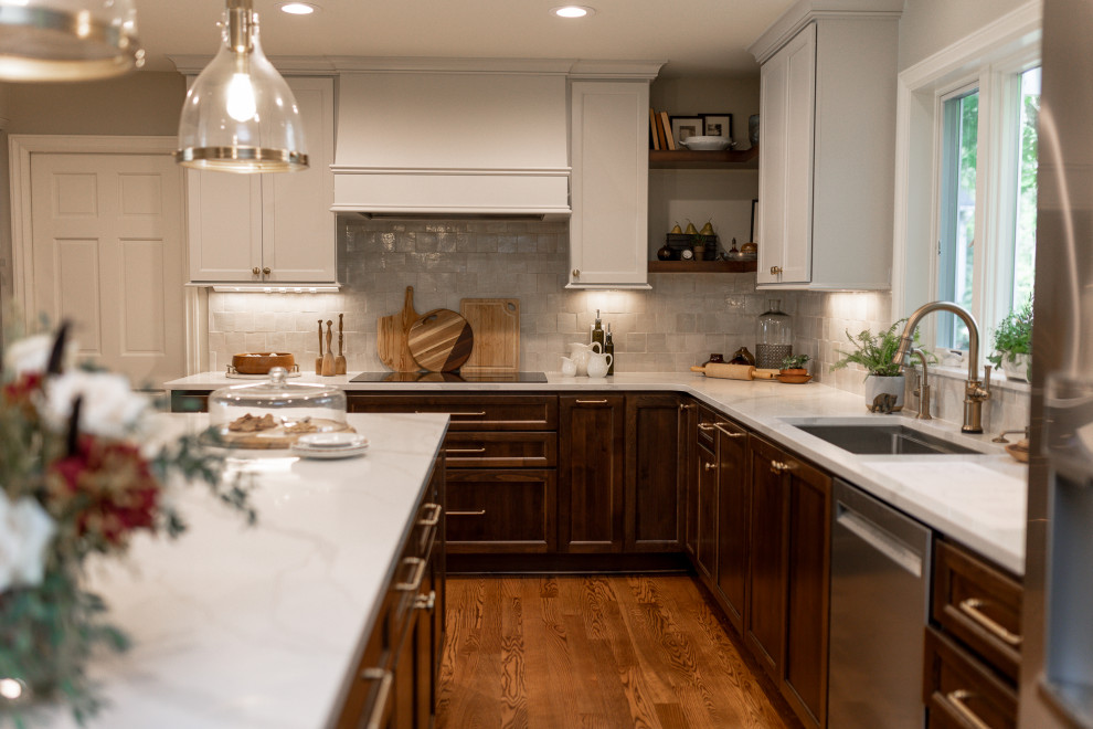 Eat-in kitchen - mid-sized transitional l-shaped medium tone wood floor and brown floor eat-in kitchen idea with an undermount sink, recessed-panel cabinets, medium tone wood cabinets, quartz countertops, beige backsplash, terra-cotta backsplash, stainless steel appliances, an island and white countertops
