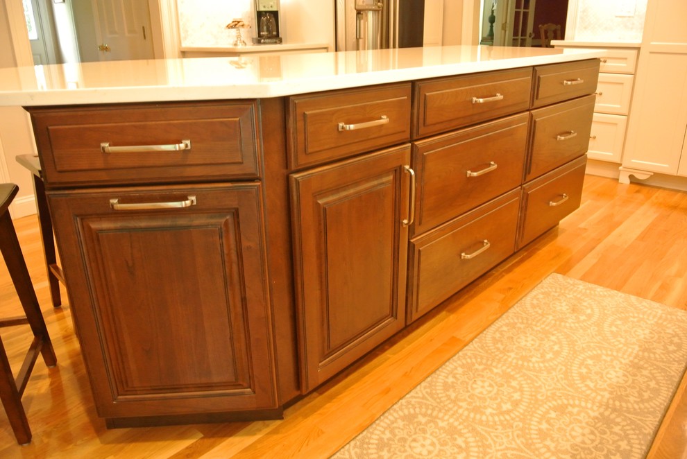 Transitional medium tone wood floor eat-in kitchen photo in Boston with an undermount sink, shaker cabinets, quartz countertops, beige backsplash, mosaic tile backsplash, stainless steel appliances, an island and white countertops