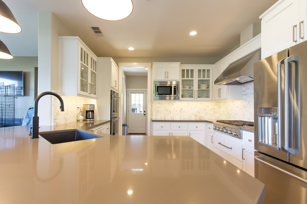 Design ideas for a modern kitchen in Sacramento with an undermount sink, white cabinets, quartz benchtops, multi-coloured splashback, stainless steel appliances and a peninsula.