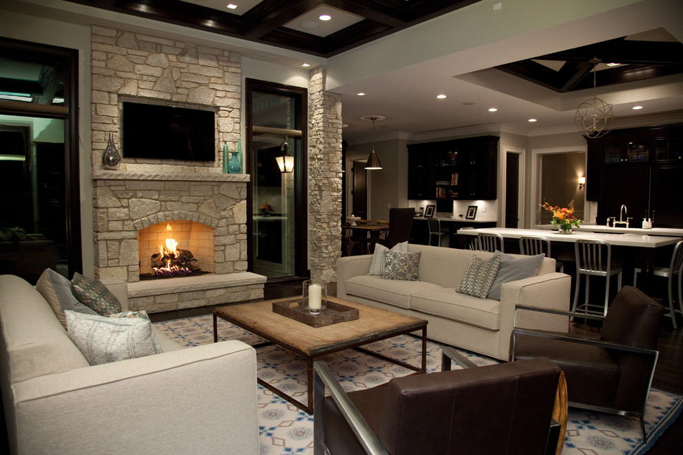 This is an example of a large traditional formal open concept living room in Chicago with a stone fireplace surround, beige walls, dark hardwood floors, a standard fireplace and a wall-mounted tv.