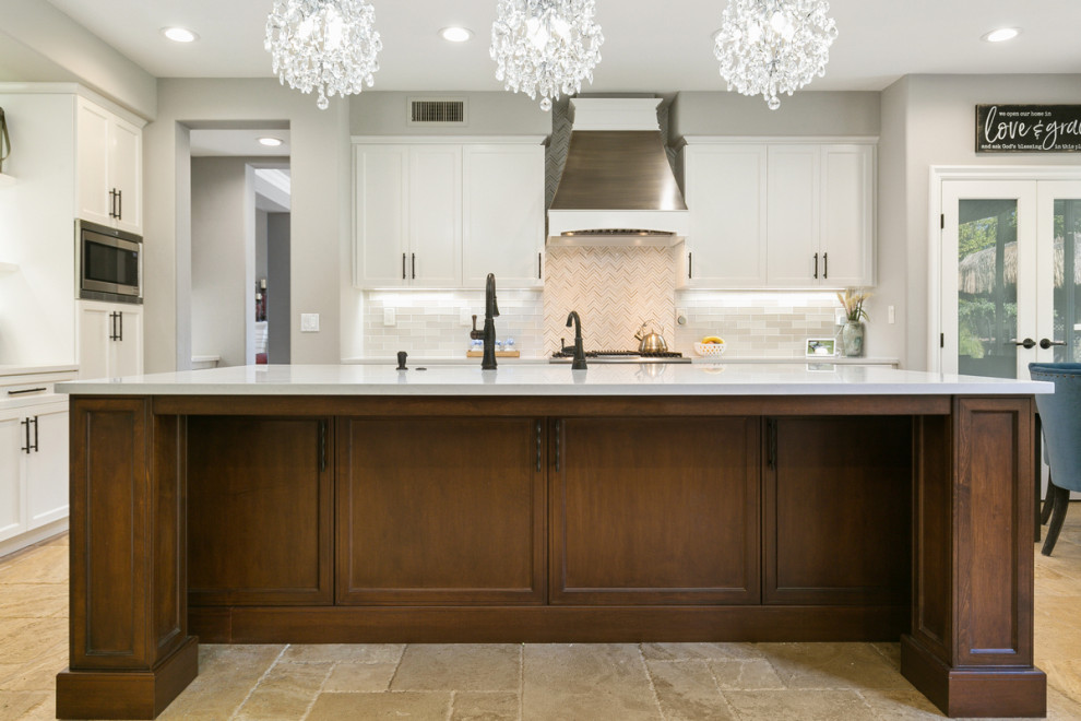 Huge transitional u-shaped travertine floor and beige floor open concept kitchen photo in Orange County with a single-bowl sink, shaker cabinets, white cabinets, quartz countertops, multicolored backsplash, stone tile backsplash, stainless steel appliances, an island and white countertops
