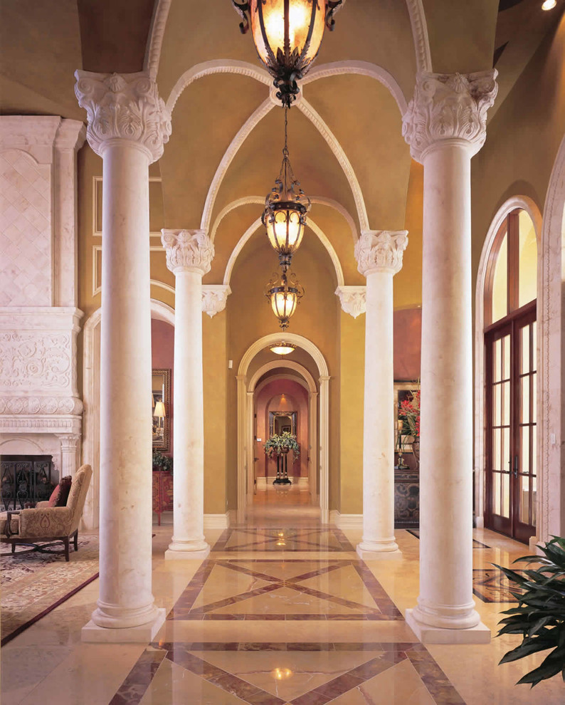 Design ideas for an expansive mediterranean hallway in Miami with yellow walls and marble floors.