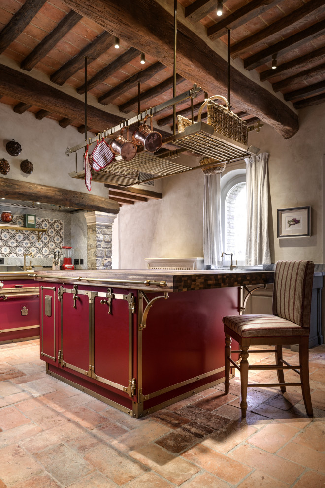 Mid-sized country single-wall separate kitchen in Florence with stainless steel cabinets, stainless steel benchtops, with island and exposed beam.