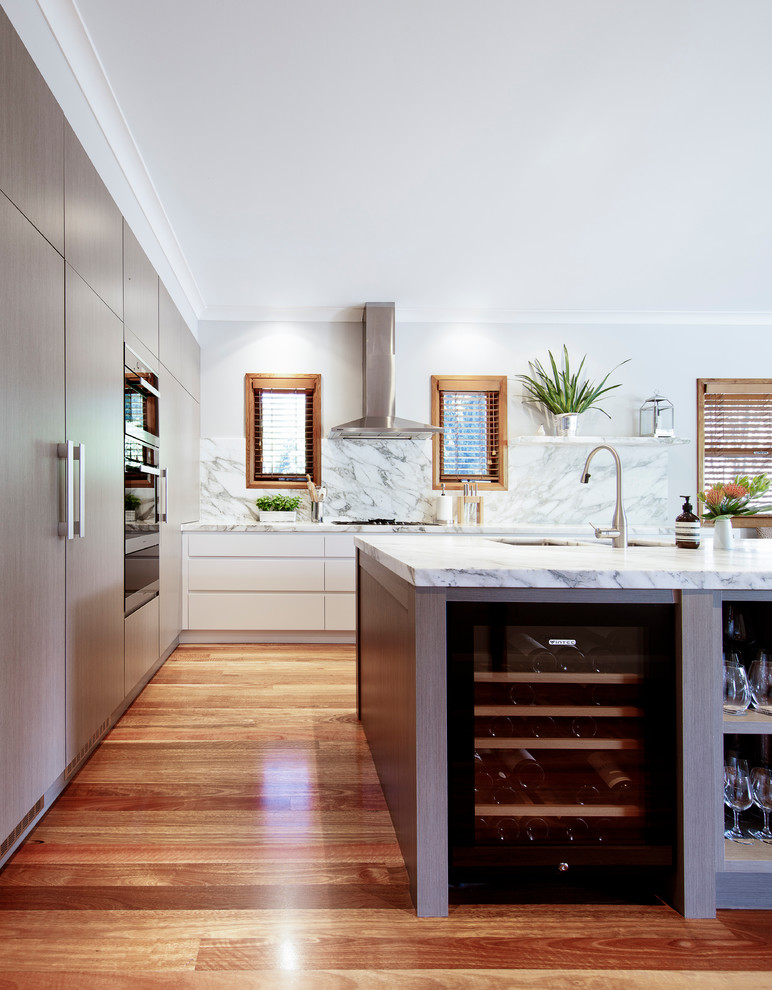 Design ideas for a large transitional l-shaped open plan kitchen in Sydney with an undermount sink, light wood cabinets, marble benchtops, multi-coloured splashback, marble splashback, panelled appliances, medium hardwood floors, with island, multi-coloured floor and multi-coloured benchtop.