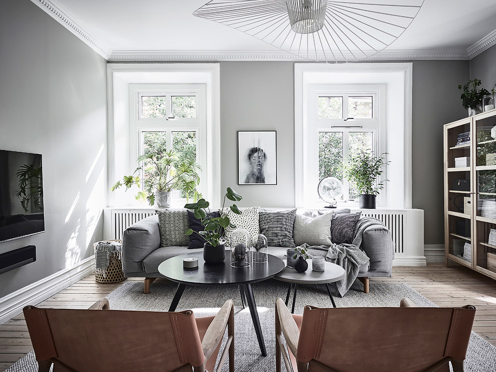 Design ideas for a mid-sized scandinavian formal living room in Gothenburg with grey walls, light hardwood floors and beige floor.