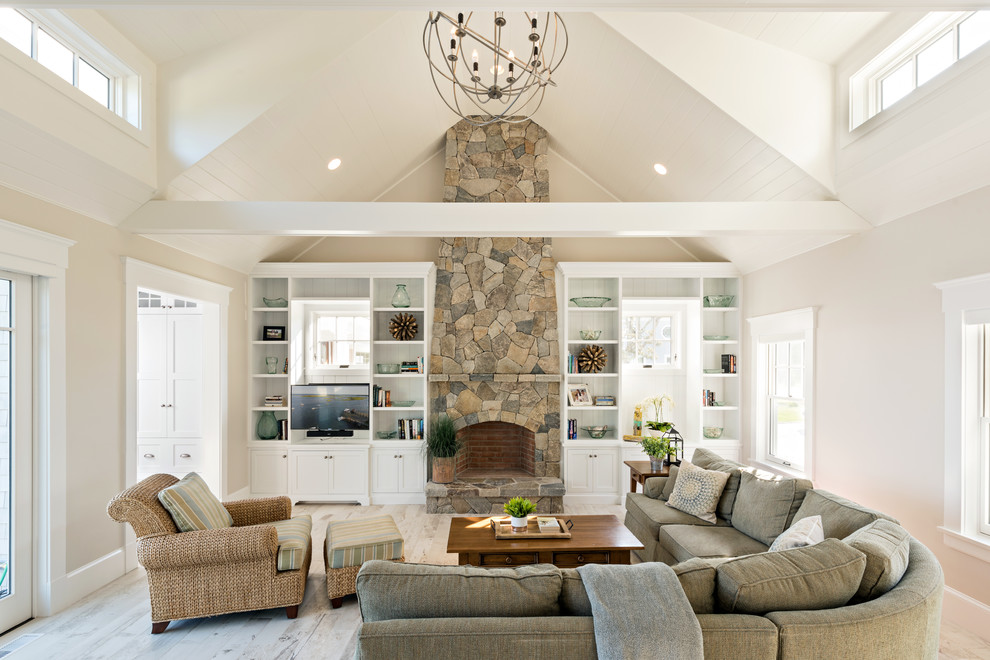 Beach style enclosed family room in Boston with a standard fireplace, a stone fireplace surround and a wall-mounted tv.