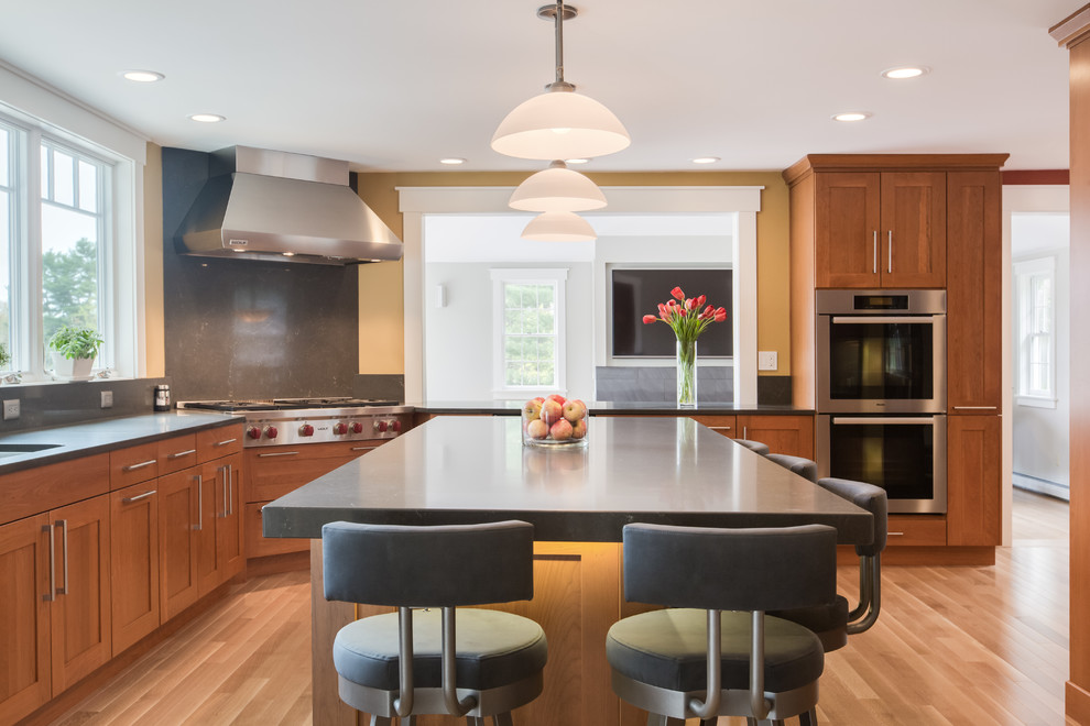 Transitional u-shaped medium tone wood floor kitchen photo in Boston with an undermount sink, shaker cabinets, medium tone wood cabinets, quartz countertops, gray backsplash, stone slab backsplash, stainless steel appliances and an island